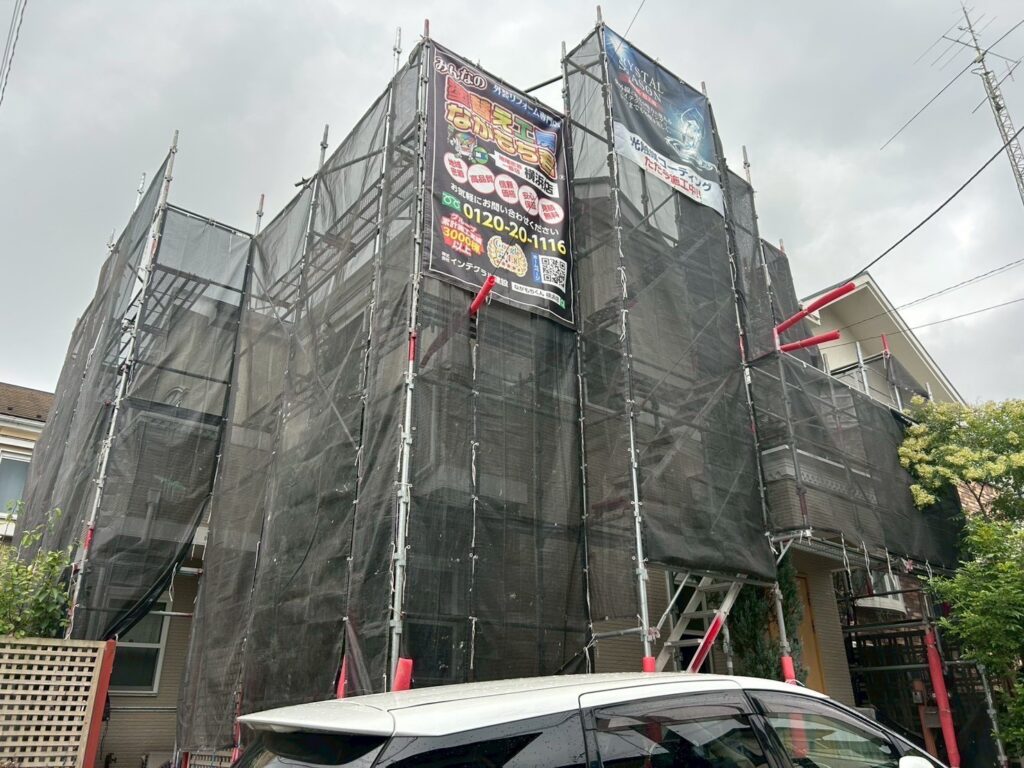 足場架けとメッシュシートを設置します。<br />
メッシュシートを設置することで塗料などが飛散することを防ぎます。